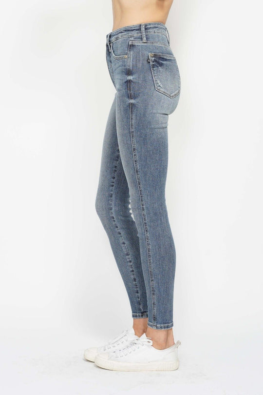 Slim medium wash jeans with back pockets and visible side seam stitching