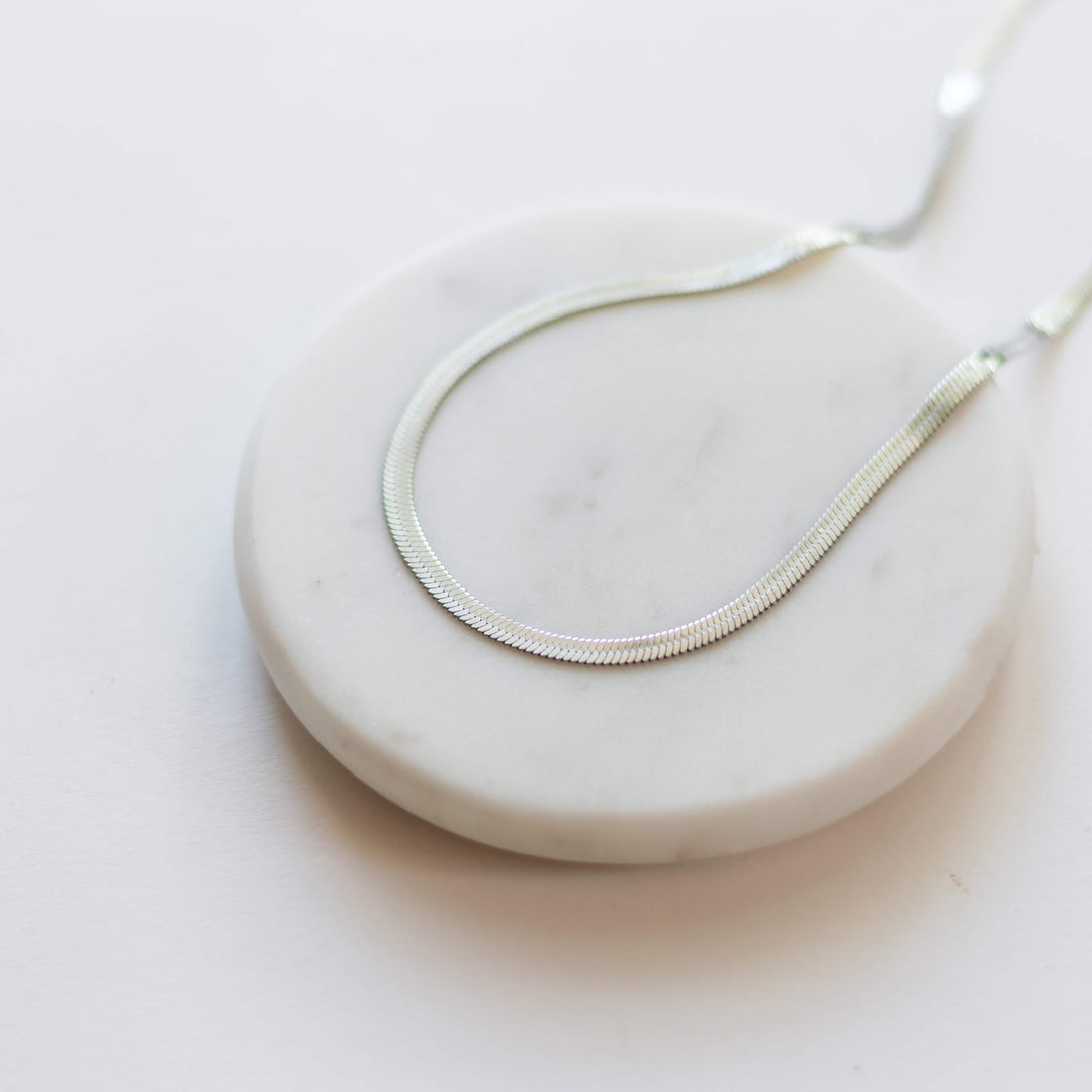 Kate Herringbone Chain Necklace in Silver, textured linked chain curve on display
