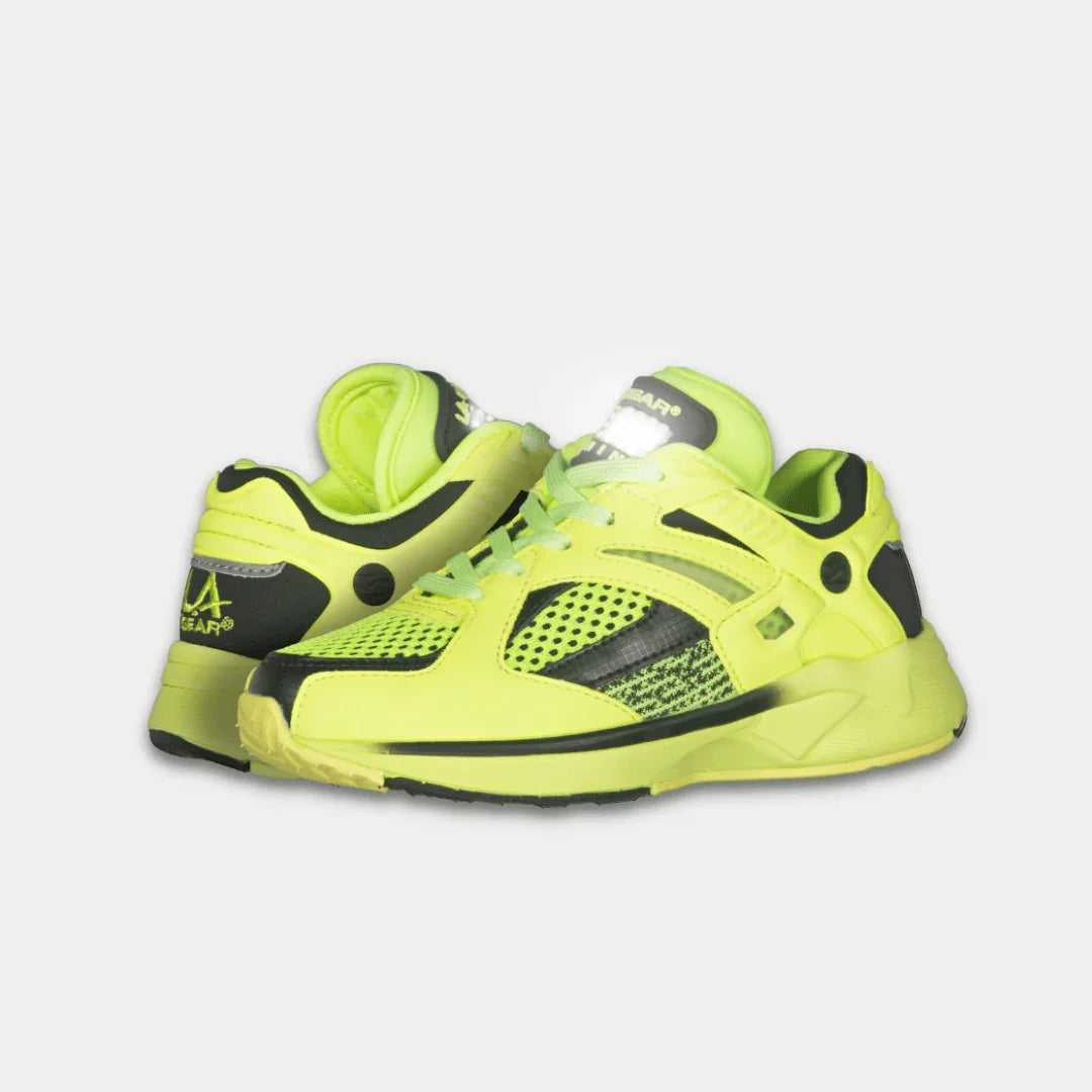 Rear view of neon yellow kids sneakers with black heel accents and cushioned back collar