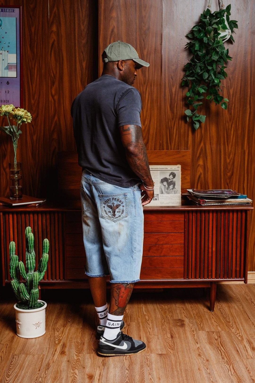 Light blue denim shorts from behind, faded wash, back yoke patch, frayed hem