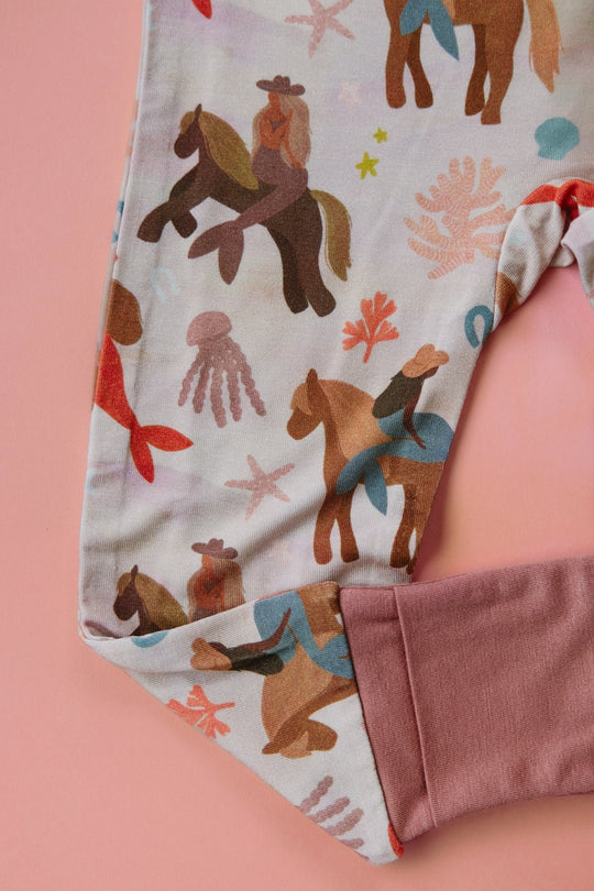 Mermaid zipper romper leg and cuff close-up with all-over animal print