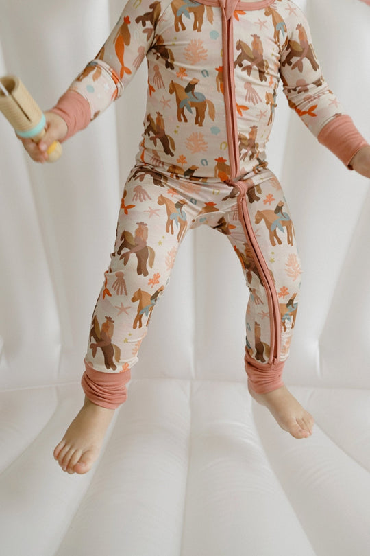 Mermaid zipper romper front view with zip closure, tied waistband, and printed legs