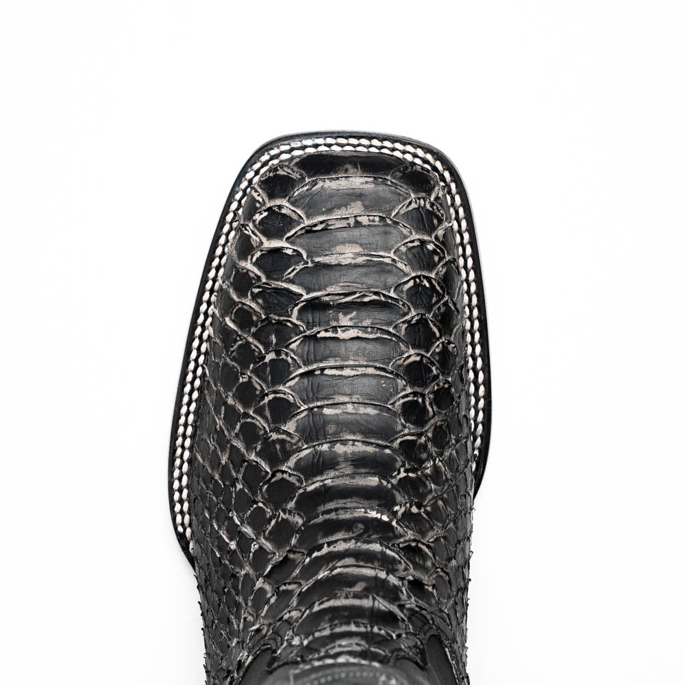 Textured boot vamp close-up with scale pattern and white edge stitching