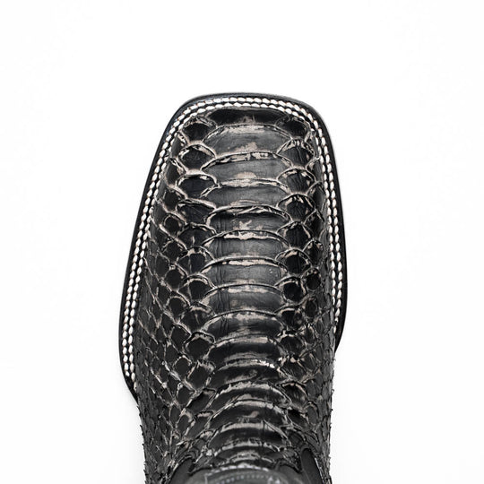 Textured boot vamp close-up with scale pattern and white edge stitching