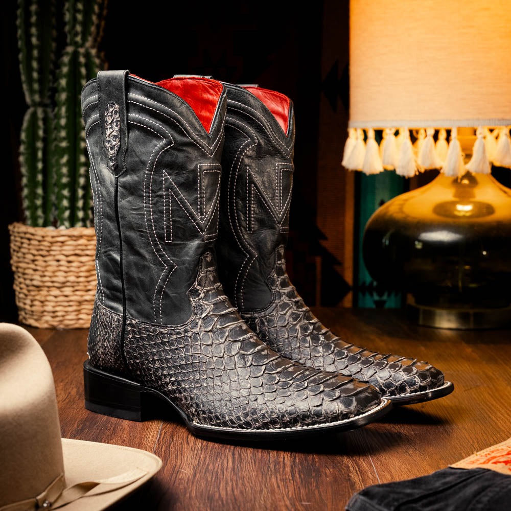 Black western boots with pointed toe, high shaft, and textured toe-and-boot panel