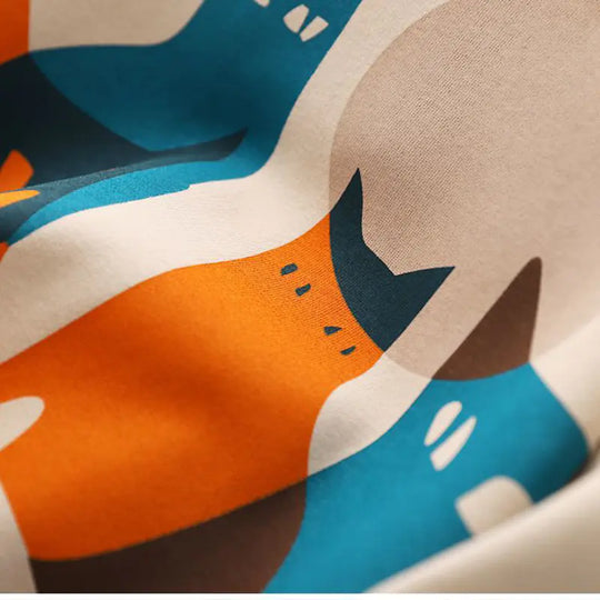 Colorful cat graphics on beige hoodie fabric with visible print details
