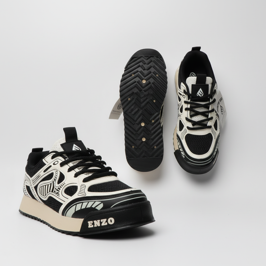 Pair of milk-white sneakers with black outsoles, front and sole details visible