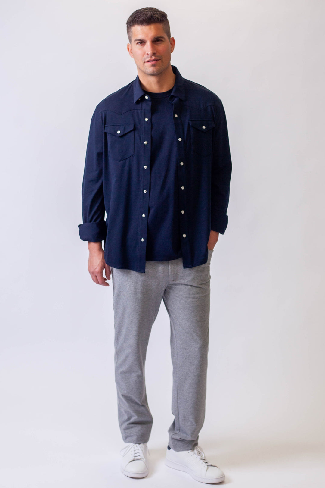 Navy Western tech shirt on model with snap-style button placket and chest pockets