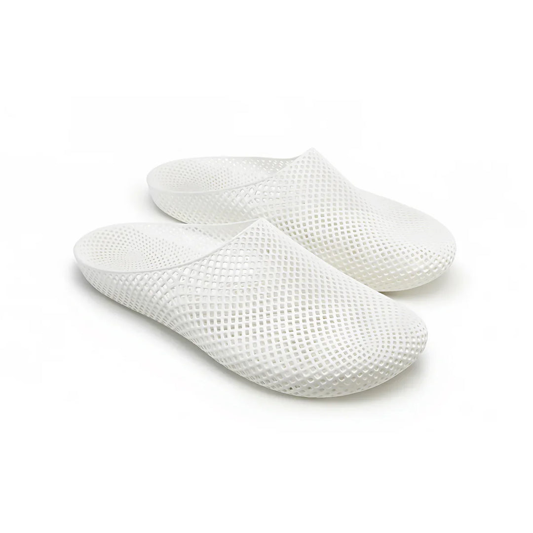 White 3D printed slippers with openwork grid texture, slip-on clog style.