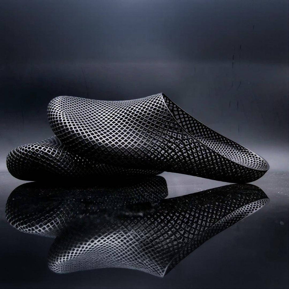 Dark 3D printed slippers with openwork mesh grid, slip-on clog style.