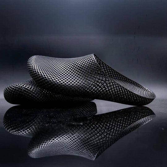 Dark 3D printed slippers with openwork mesh grid, slip-on clog style.