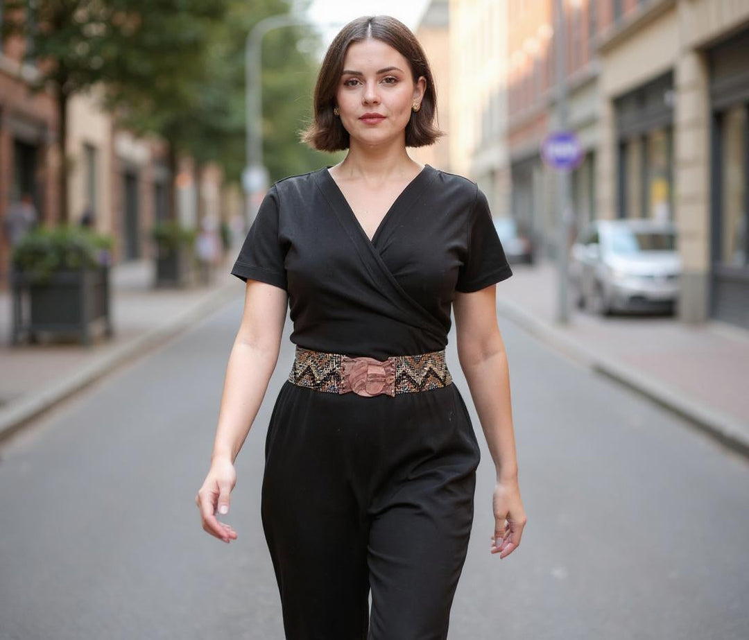 Black wrap V-neck jumpsuit with wide gold chevron belt