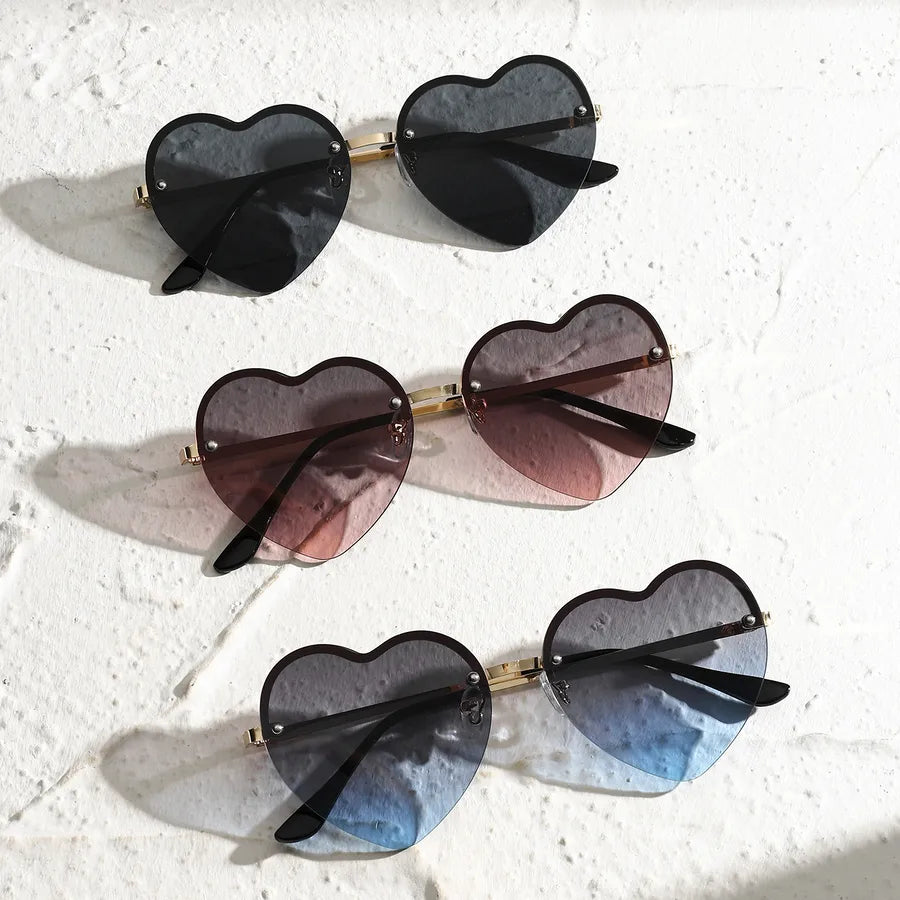Set of heart-shaped half-rim sunglasses in black, mauve, and gray-blue