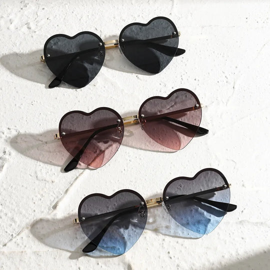 Set of heart-shaped half-rim sunglasses in black, mauve, and gray-blue