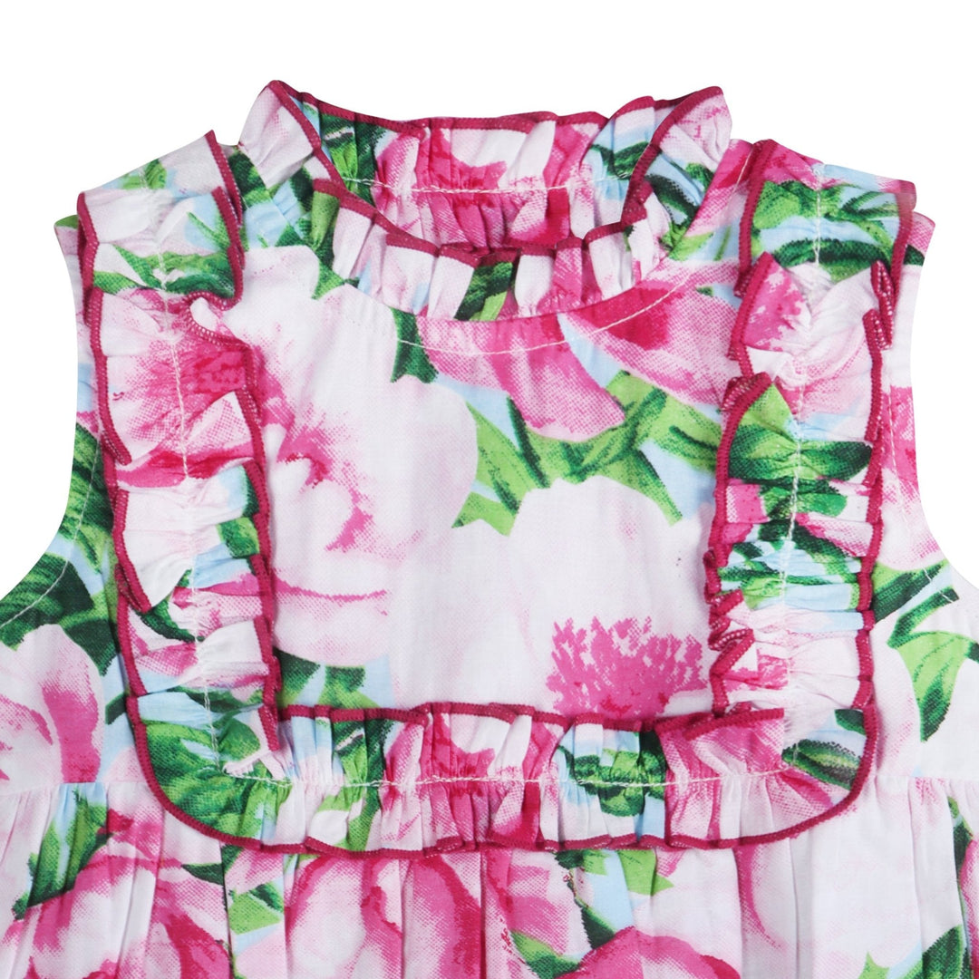 Close-up: pink floral girl romper with ruffled collar and gathered waist