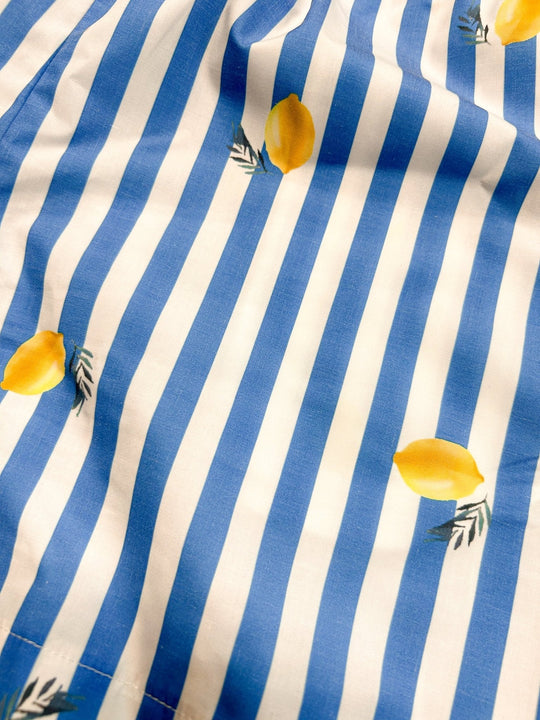 Close-up fabric: blue-and-white vertical stripes with small yellow lemon motifs