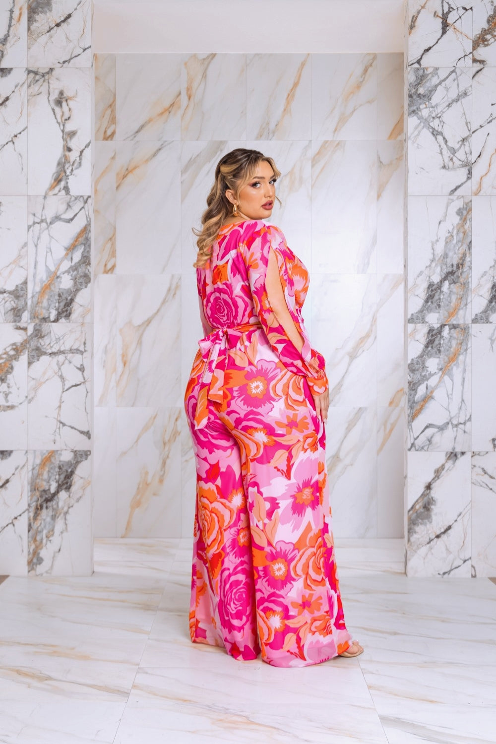 Pink floral jumpsuit, belted waist, long split sleeves, side view