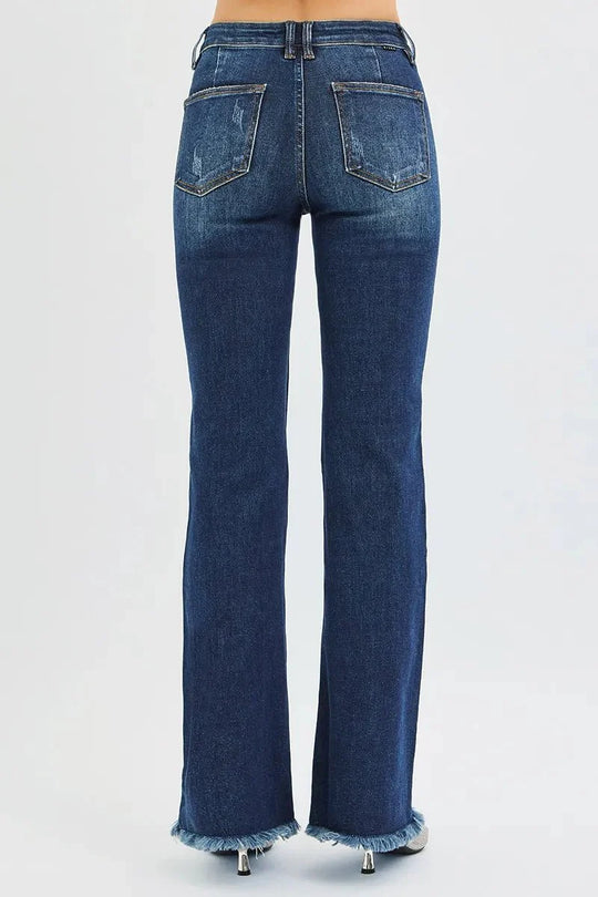 Back view dark wash flare jeans with two back pockets, belt loops, frayed hem