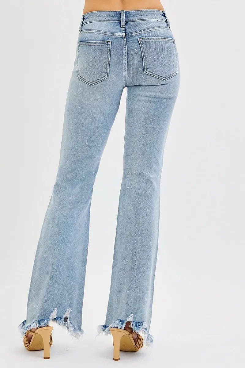 Medium wash flare jeans back view with stitched pockets and frayed cuffs