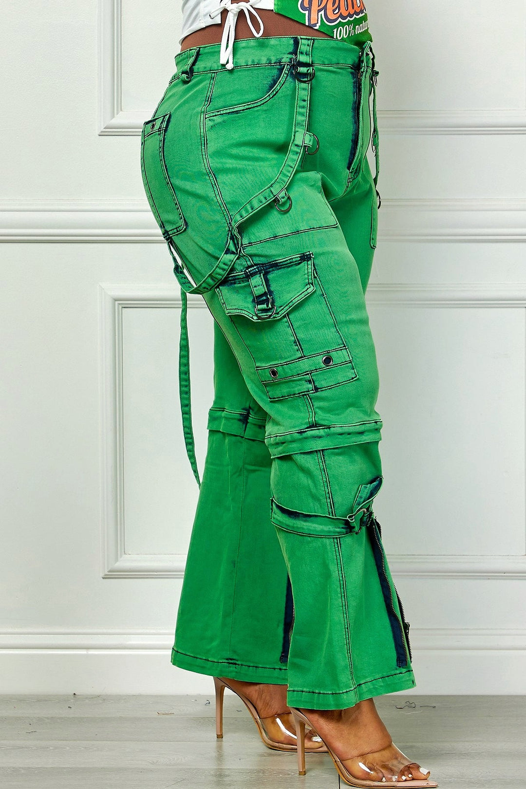 Green utility cargo denim pants, side view with dangling belt straps and leg pockets