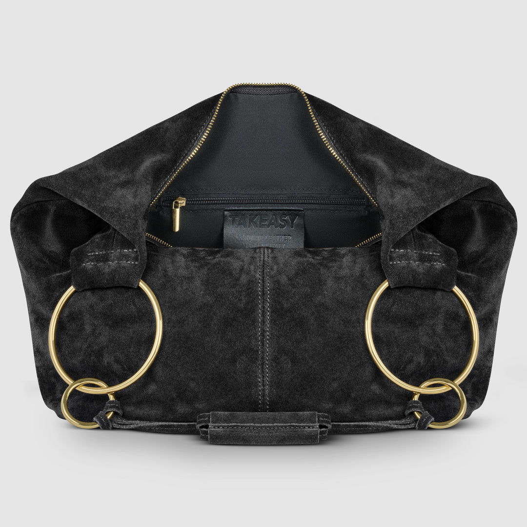 Black suede hobo bag interior view with front zipper pocket, gold hardware, and ring handles