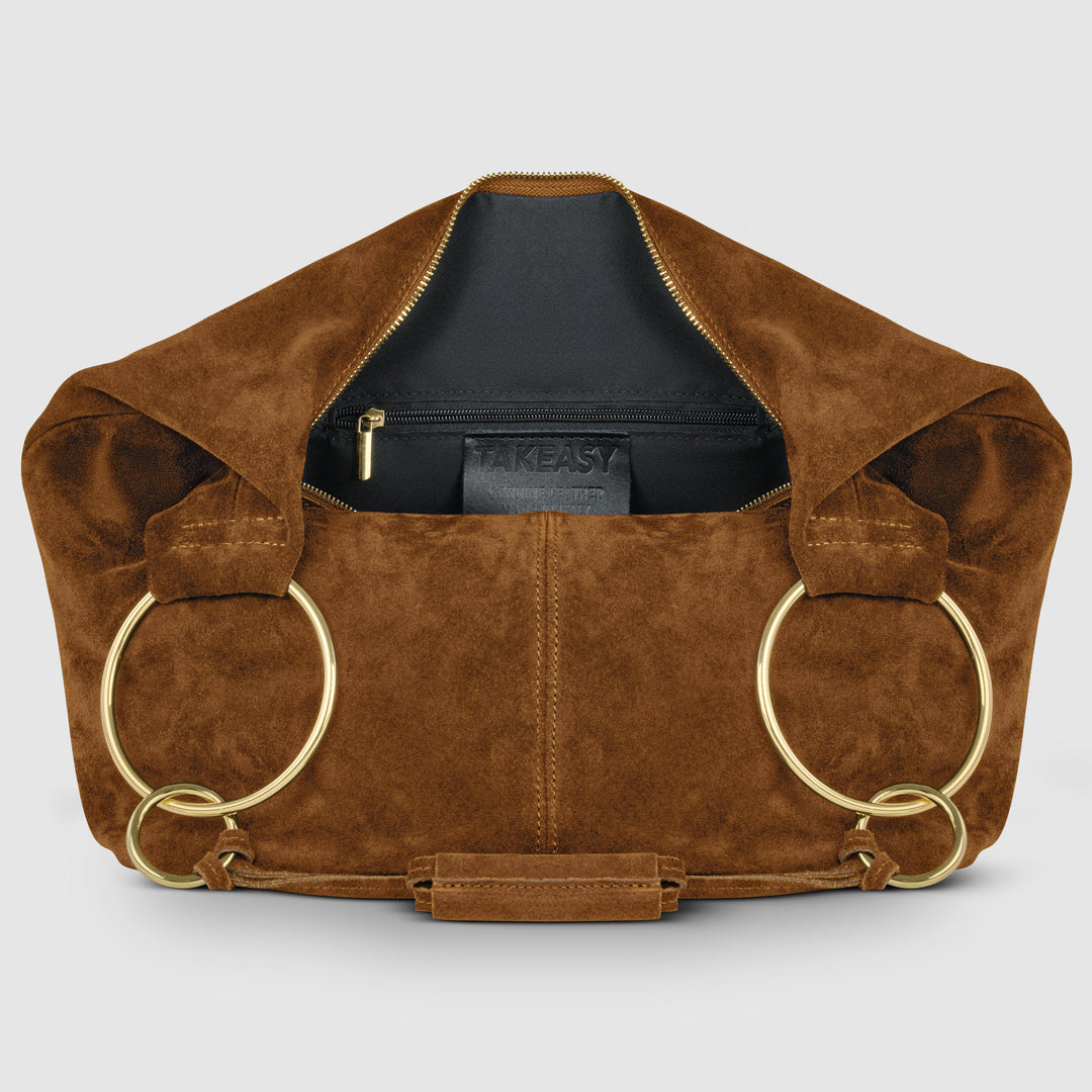 Brown suede hobo bag interior view with front zipper pocket, gold hardware, and ring handles