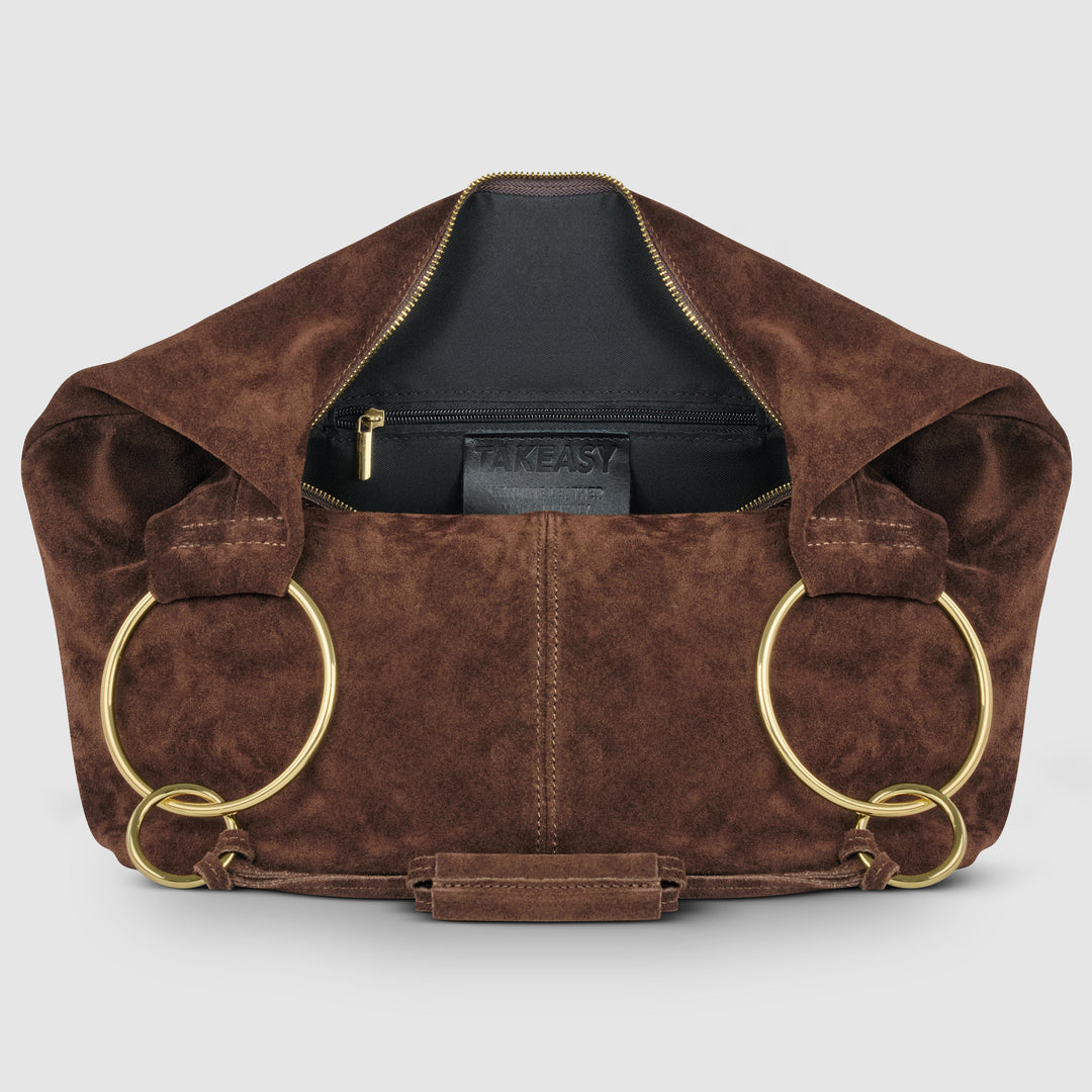 Brown suede hobo bag with zip-top opening, interior lining, and long ring handles