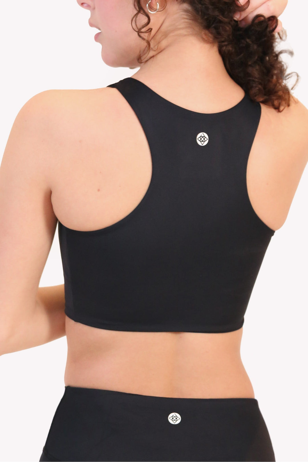 Dark black back of the classic renew bra with center logo and racerback straps