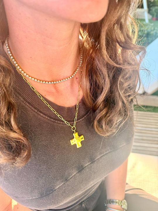 Gold-tone cross charm pendant necklace layered with a fine beaded chain