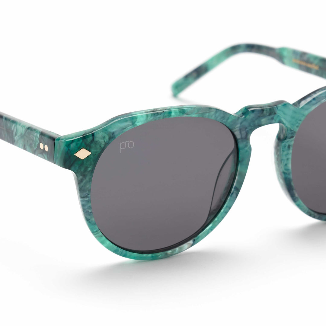 Teal marbled Tribe sunglasses close-up, dark oval lenses