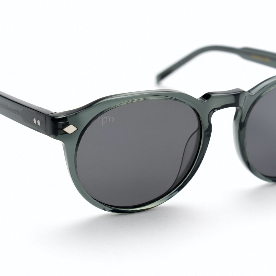Tribe sunglasses close-up: dark gray frame, dark lenses, small diamond detail