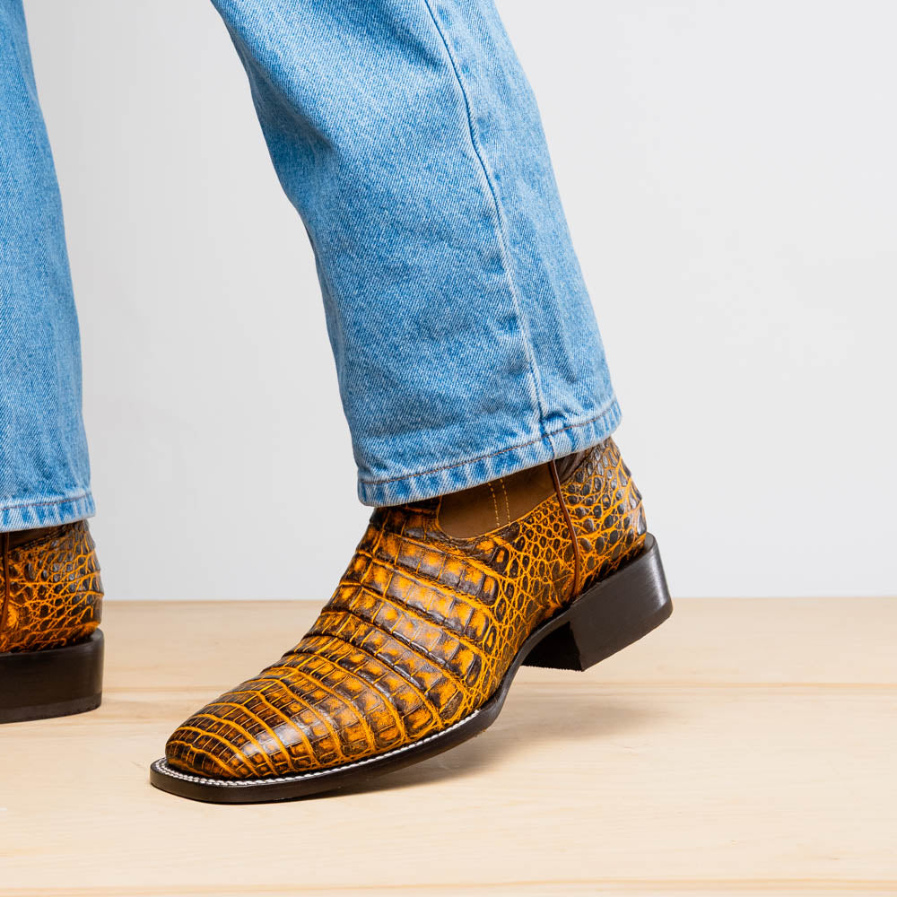 Tucson Mustard/Brown cowboy boots on model, front-side view of pointed toe