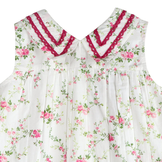 Close-up bodice of white rosebud cotton dress with burgundy embroidered collar trim