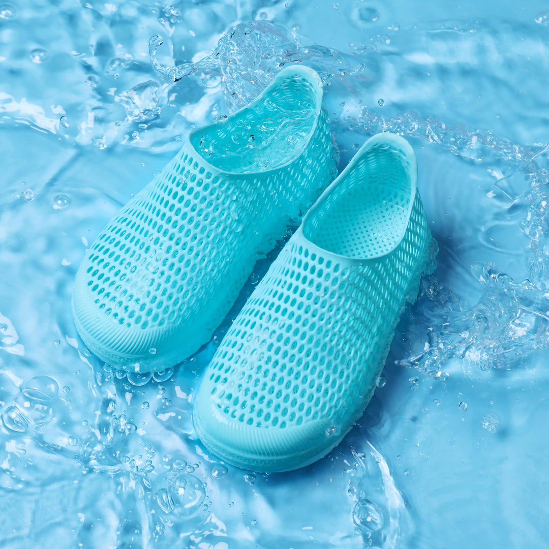Light blue kids slip-on shoe with perforated mesh upper and thick sole, water-ready look