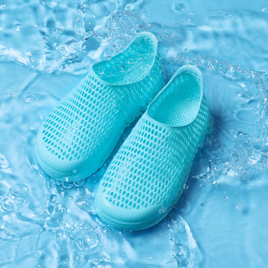 Light blue kids slip-on shoe with perforated mesh upper and thick sole, water-ready look