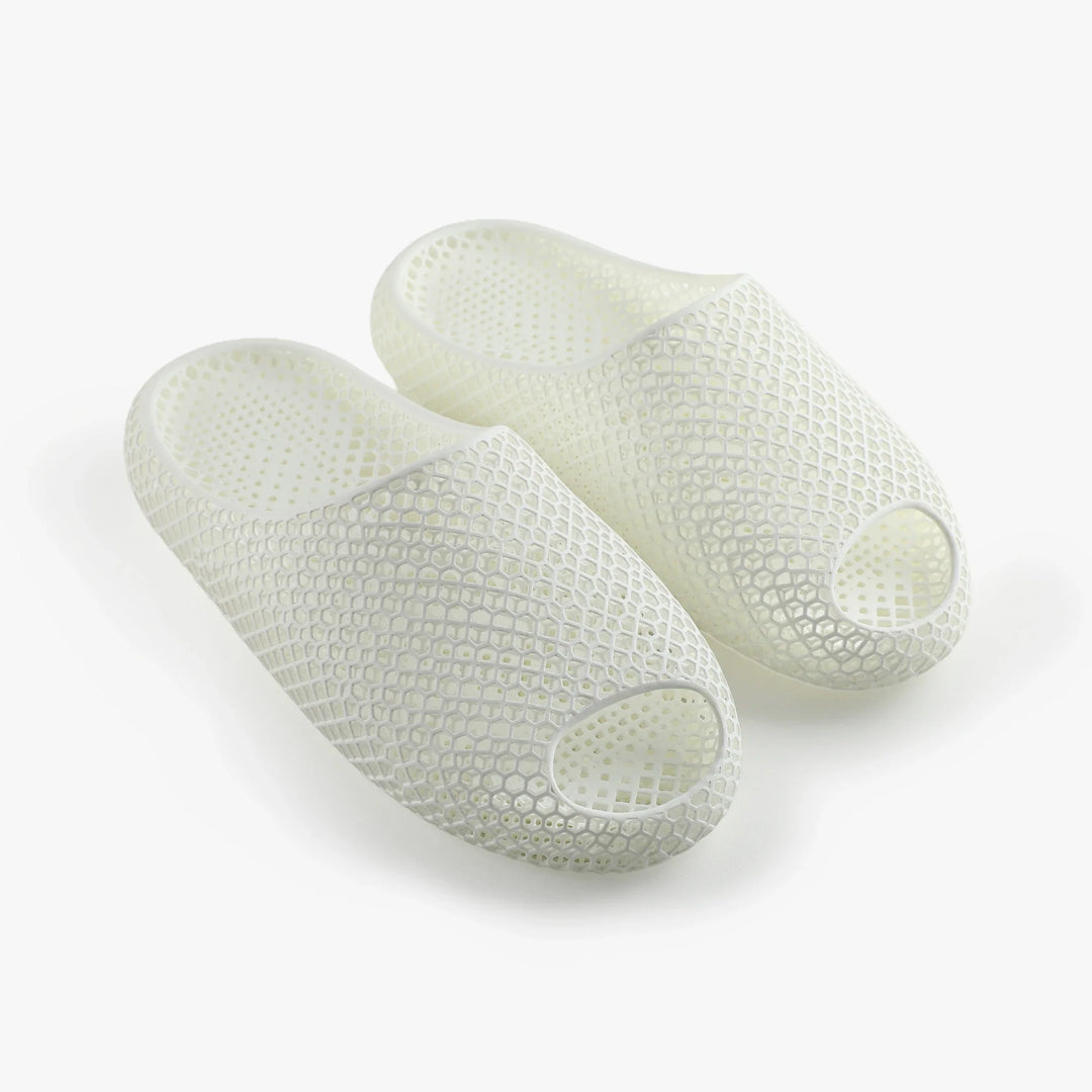 White 3D-printed slippers, two-piece pair with open toe and hexagonal honeycomb texture