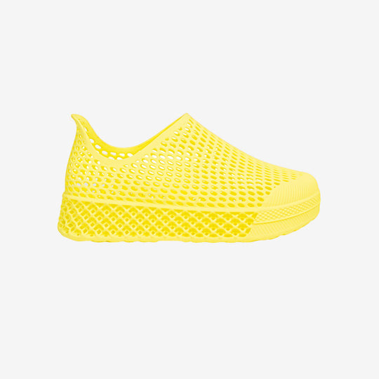 Yellow 3D printed kids slip-on shoe with perforated mesh upper and thick sole