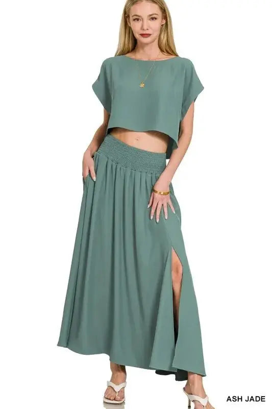 Front view: Ash Jade crop top with simple neckline and split-front tiered maxi skirt